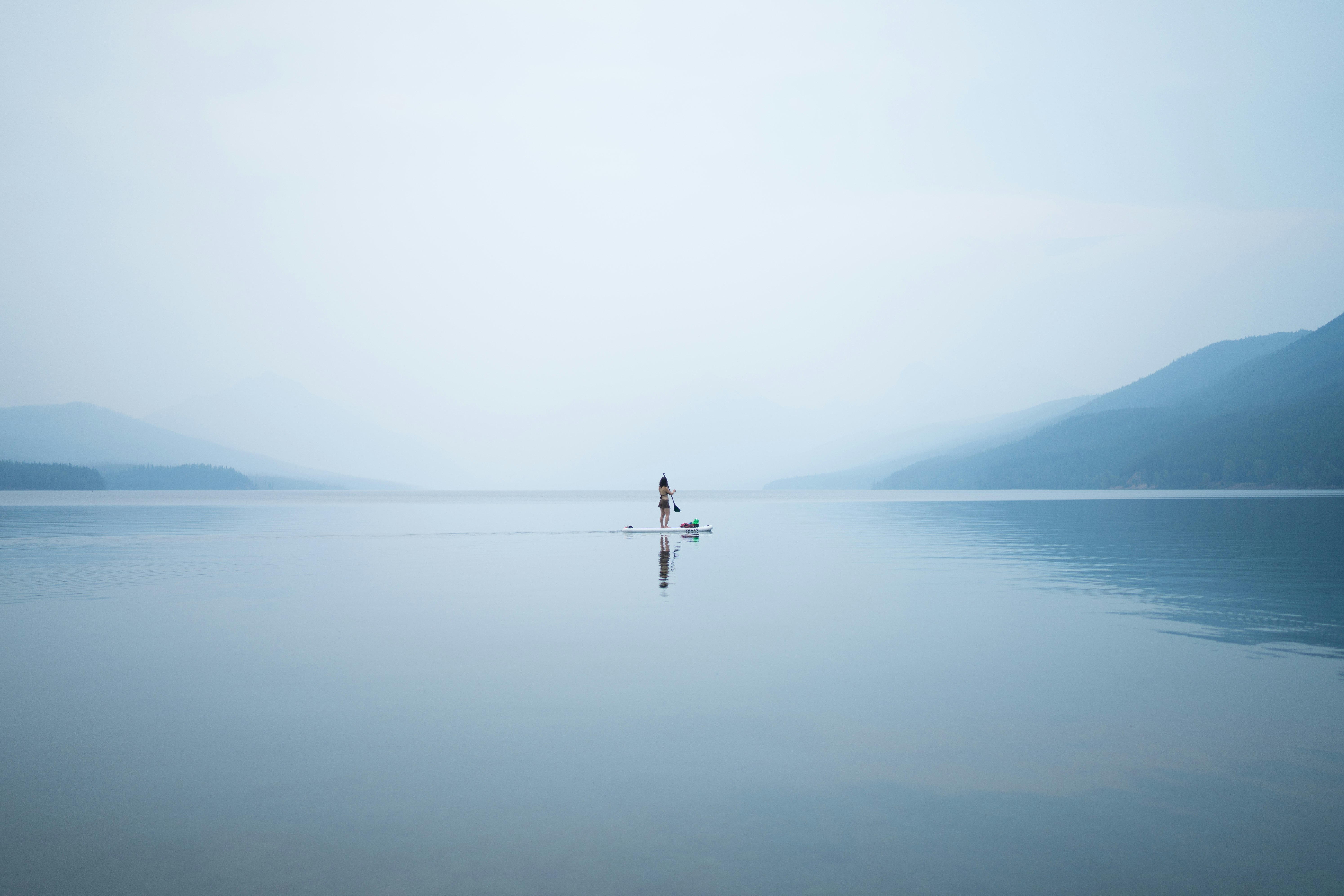 photo of person on calm body of water